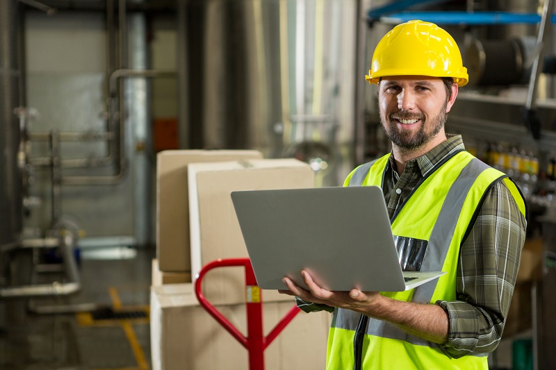 smiling-male-worker-using-laptop-distribution-warehouse - 副本.jpg